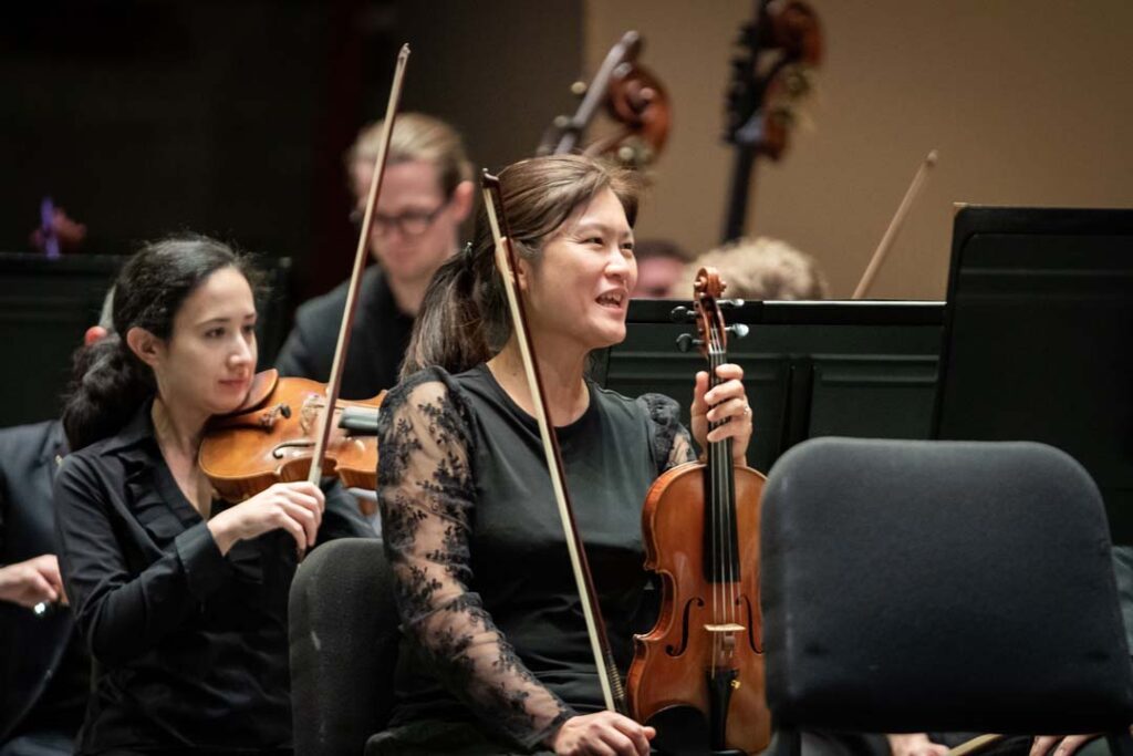 kso musician smiles while on stage