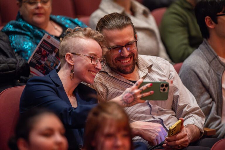 a young couple takes selfie in concert hall - ticket policies and questions