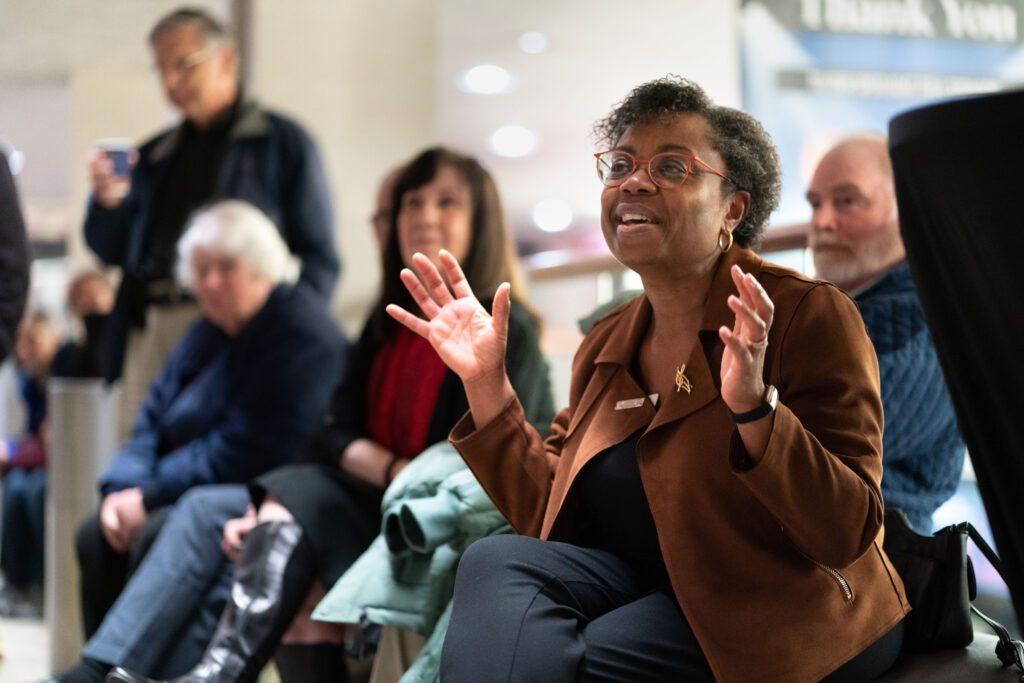 woman looks exciting while asking a question at AfterWORDS - concert experience