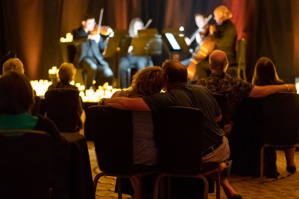 couple watches candlelight concert - gift certificates