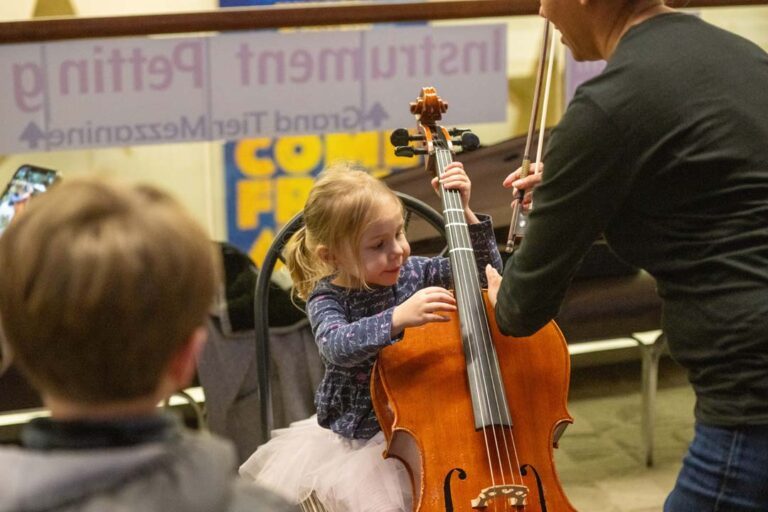 young girl learns to play the cello