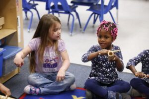 young girl plays percussion instrument