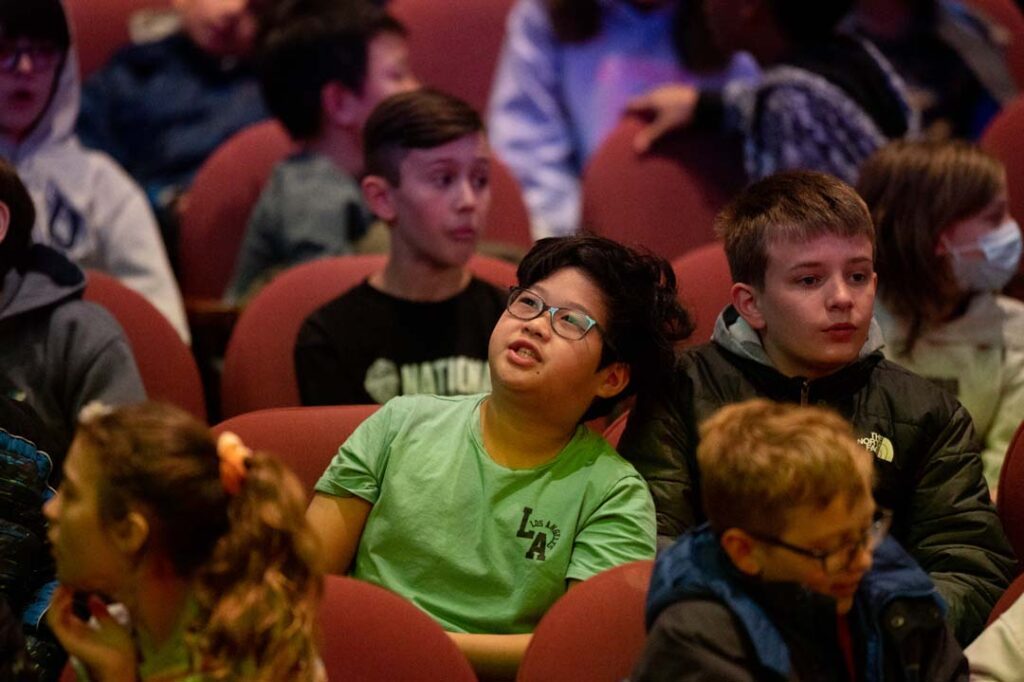 young boy looks at stage