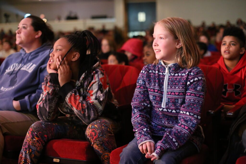 young girl enthralled by orchestra concert