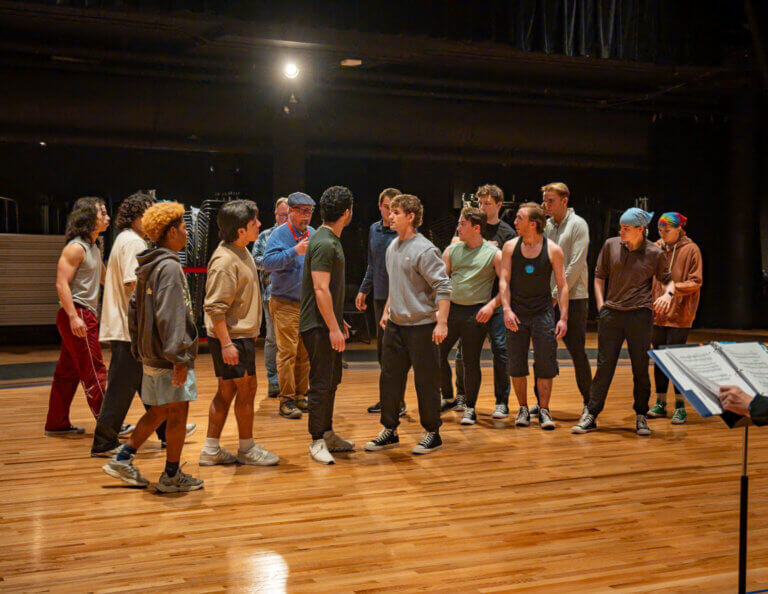 The Sharks, on the left, and the Jets, on the right, have a tense encounter in an early scene in the Kalamazoo Symphony Orchestra production of “West Side Story.” Photo by Hananiah Hardin.